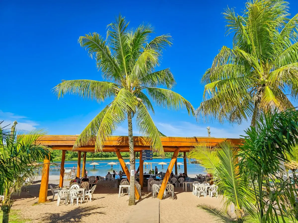 Beach bar at Praia da Figueira, with shaded tables by the lagoon