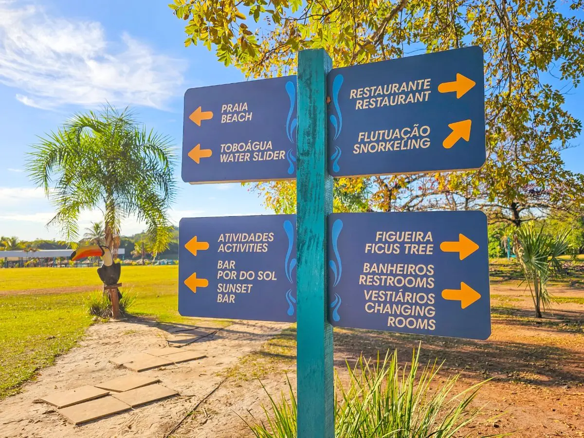 Signpost for the activities at Praia da Figueira: restaurant, float trip, waterslide and bar