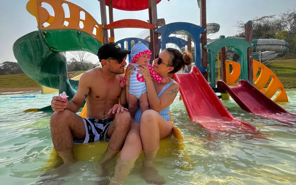 Family with a baby at the water playground in the kids area at Praia da Figueira