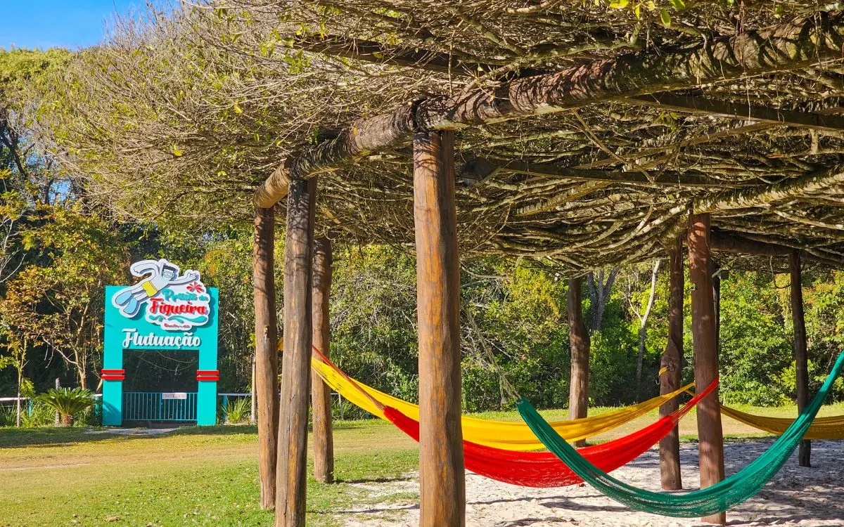 Colorful hammocks in a shaded rest area at Praia da Figueira